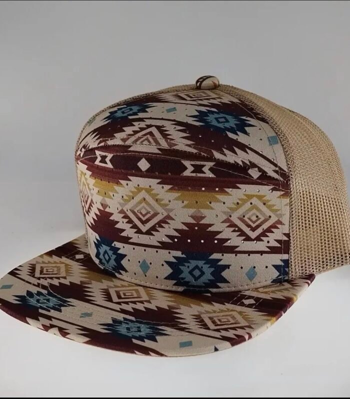 Beige Southwest flat-brim trucker hat featuring brown, blue, and cream geometric patterns with mesh side panels