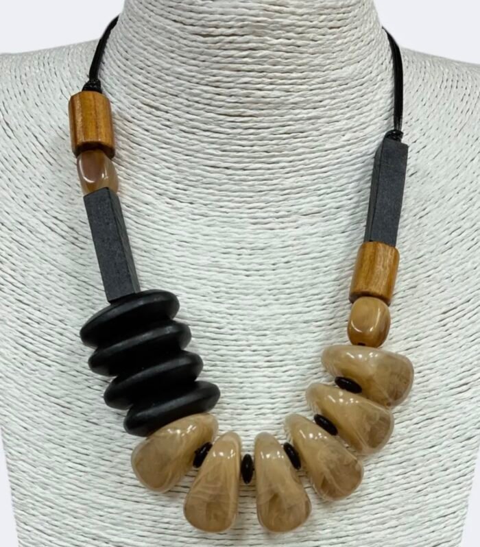 Natural acrylic and wood chunky statement necklace displayed on a white jewelry bust
