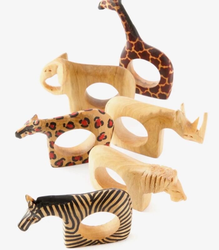 Handcrafted set of six Jacaranda wood napkin rings featuring safari animals, including giraffe, zebra, elephant, and antelope designs. Perfect for African-inspired table décor.