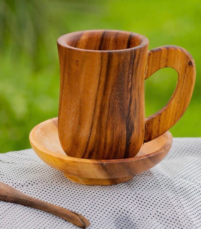 Handcrafted acacia wood mug with matching saucer and spoon made from natural wood.