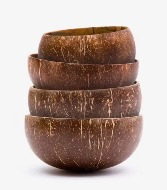 Set of handcrafted coconut bowls in small and jumbo sizes stacked together.