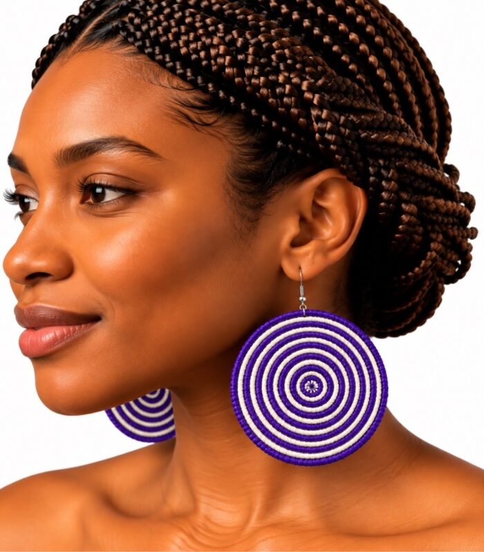 Handwoven raffia two-tone disc earrings in natural and purple worn by model